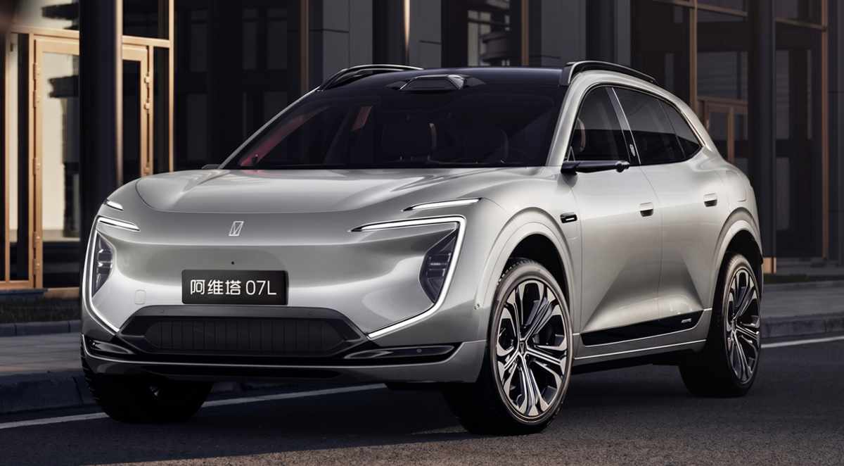 Vista frontal en tres cuartos de la nueva SUV eléctrica Avatr 07L color plata, circulando por una calle urbana y destacando sus estilizadas luces diurnas LED en forma de C.