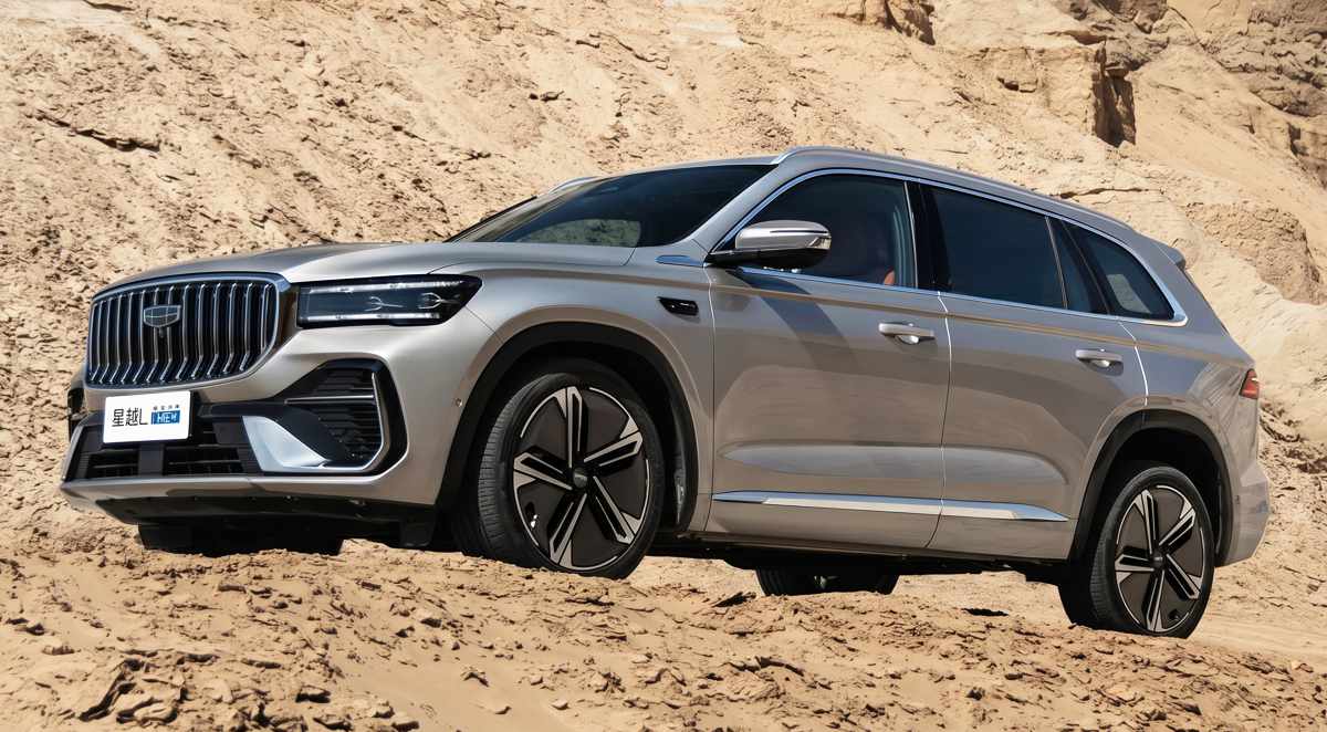 Vista lateral y frontal de la nueva SUV híbrida Geely Monjaro i-HEV, conocida como la Koleos china, rodando sobre un desafiante terreno desértico.