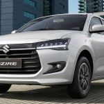 Plano frontal en tres cuartos del sedán Suzuki Dzire con tecnología híbrida ligera en color blanco, uno de los carros que más bajó de precio en Colombia durante mayo.