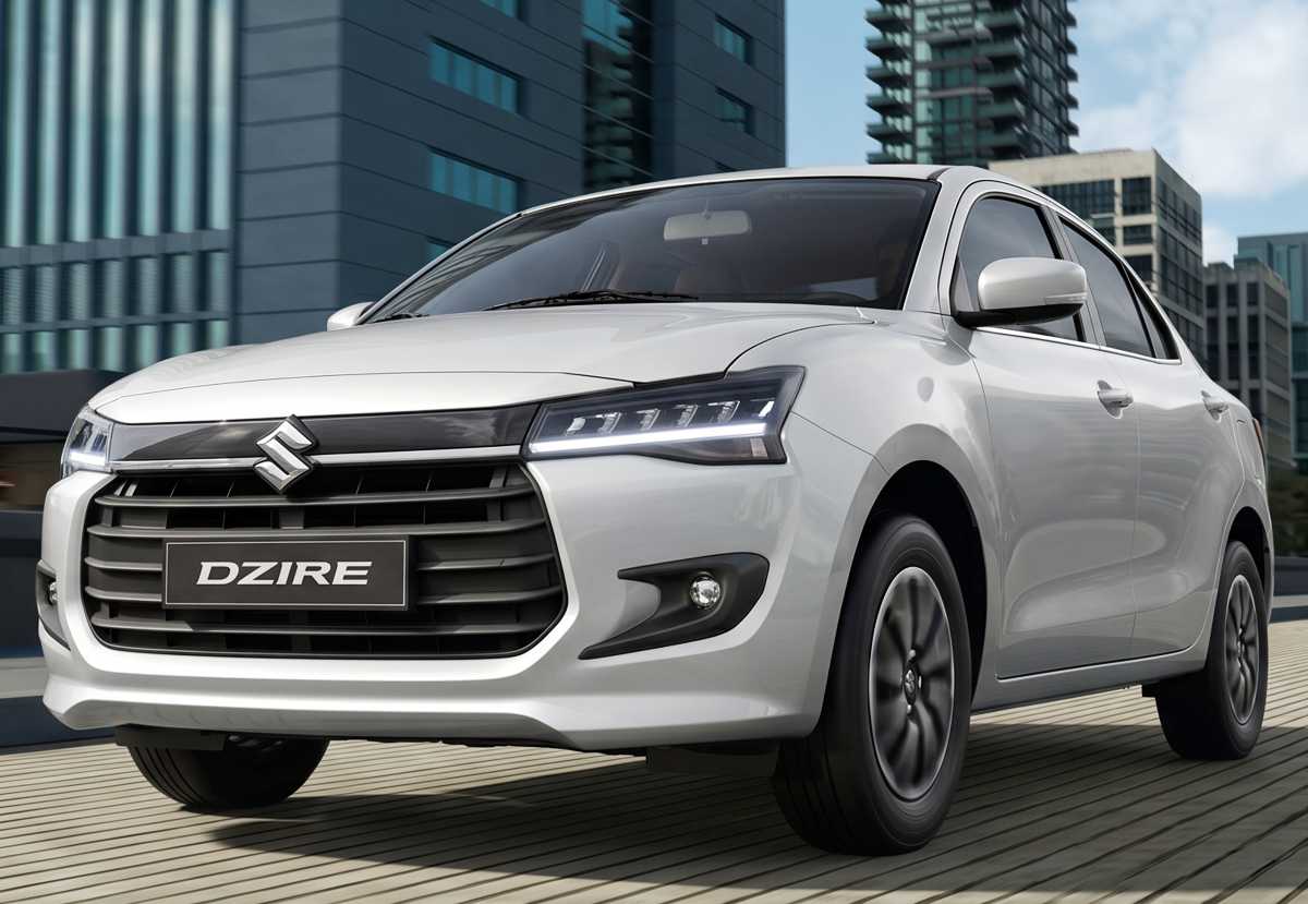 Plano frontal en tres cuartos del sedán Suzuki Dzire con tecnología híbrida ligera en color blanco, uno de los carros que más bajó de precio en Colombia durante mayo.