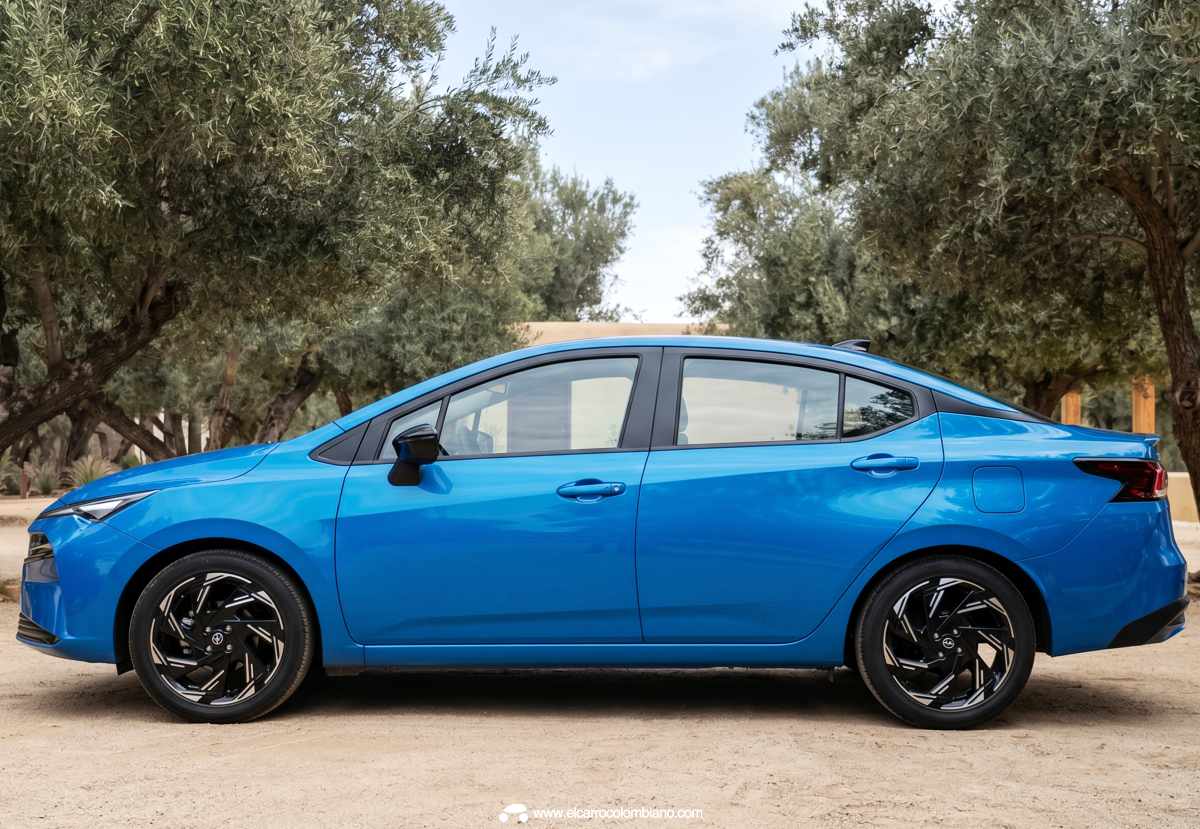 Vista de perfil completo del Nissan Versa 2027 en color Azul Acero, detallando la altura libre al suelo de 17,3 cm y sus líneas laterales.