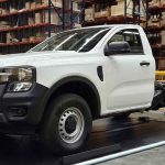 Ford Ranger XL Chasis color blanco exhibida sobre una plataforma negra con iluminación azul, destacando su estructura trasera desnuda y lista para carrozar durante su lanzamiento en Colombia.