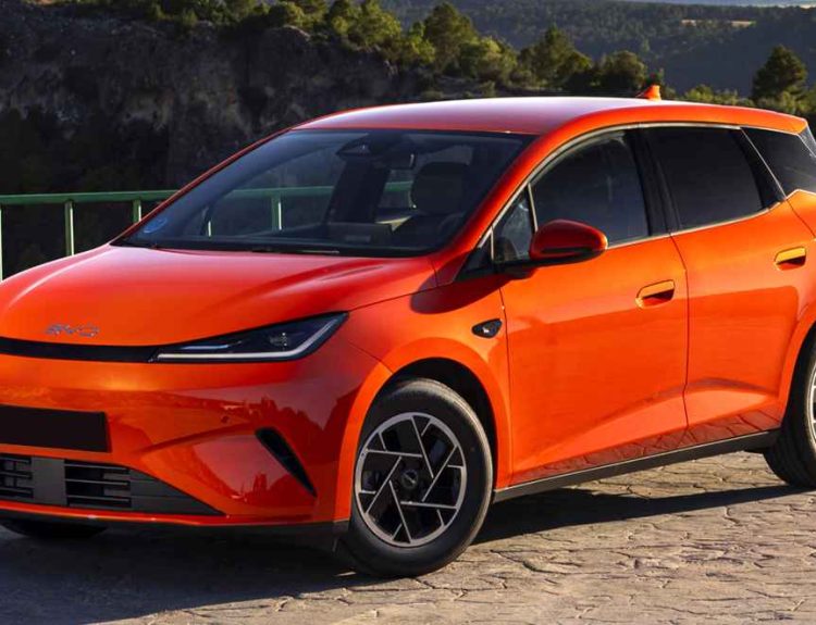 Vista frontal de tres cuartos del nuevo BYD Dolphin G DM-i híbrido enchufable color naranja estacionado en una carretera, destacando su nuevo capó horizontal, parrilla cerrada y luces LED afiladas.