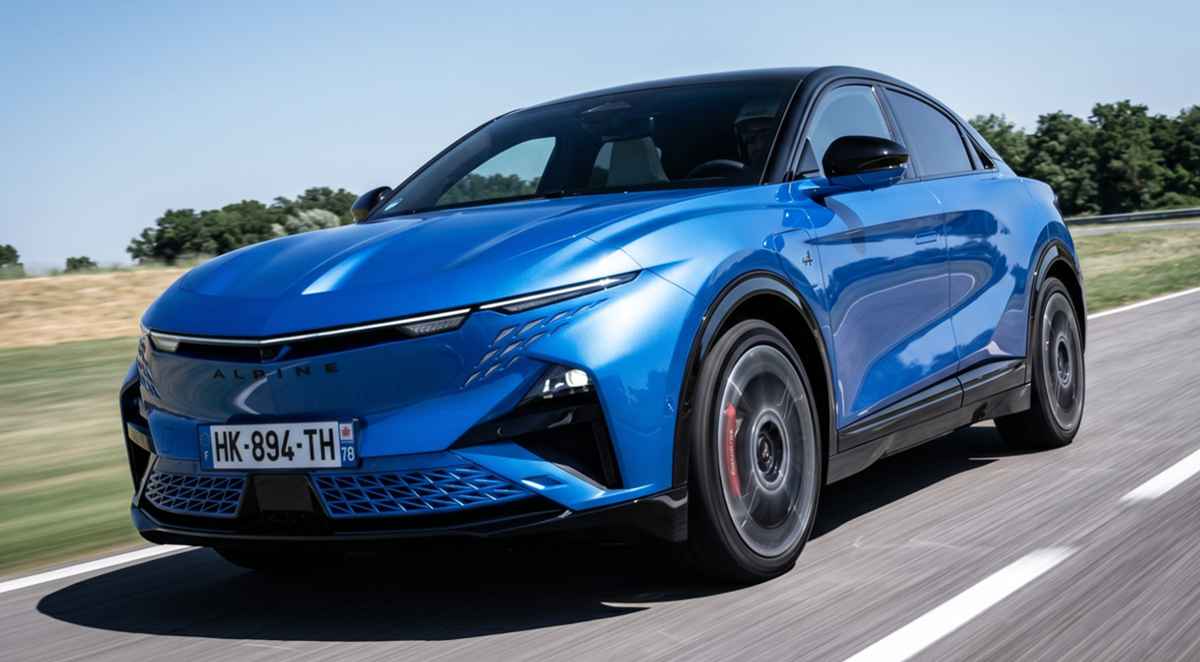 SUV eléctrico deportivo Alpine A390 GTS de color azul rodando a alta velocidad sobre el asfalto, destacando su diseño aerodinámico frontal y rines en movimiento.