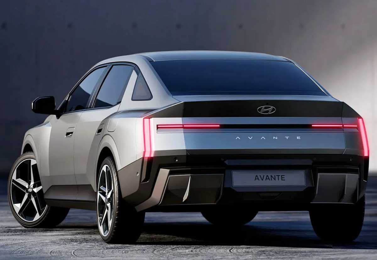 Diseño posterior del Hyundai Elantra 2027 en color plata mate, luciendo luces traseras LED rojas unidas que forman un patrón visual con la letra H, un alerón tipo cola de pato integrado y un bumper inferior robusto en negro.