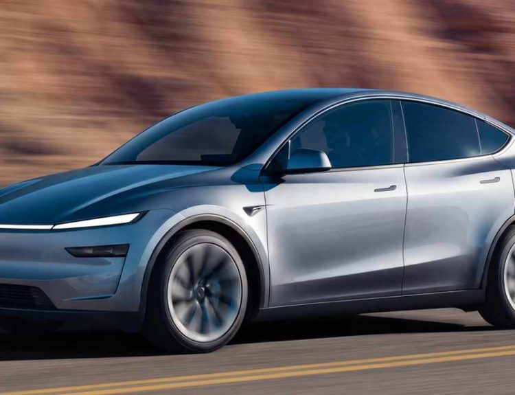 Tesla Model Y plateado en movimiento por una carretera despejada con montañas de fondo, representando el carro más vendido de Colombia en mayo.