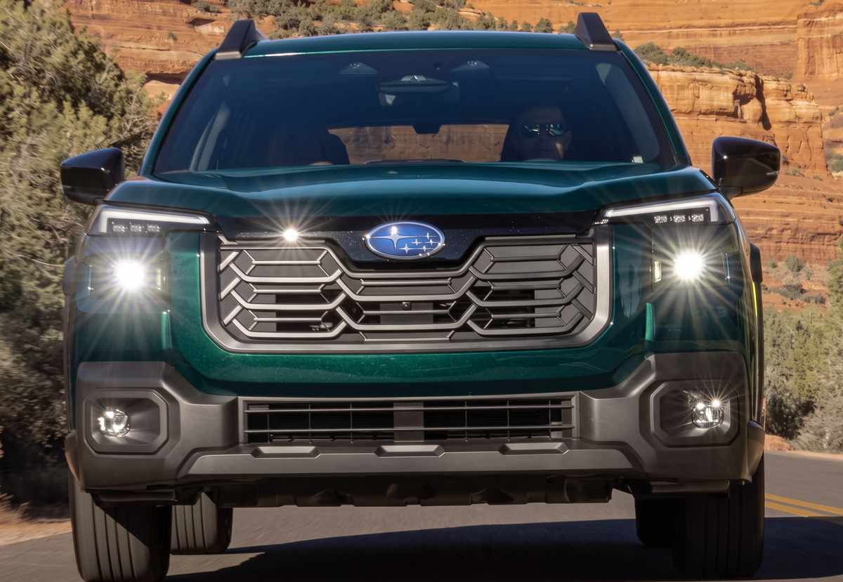 Plano frontal en movimiento de la Subaru Outback 2026, resaltando su parrilla hexagonal oscura y luces diurnas LED separadas de los faros principales.