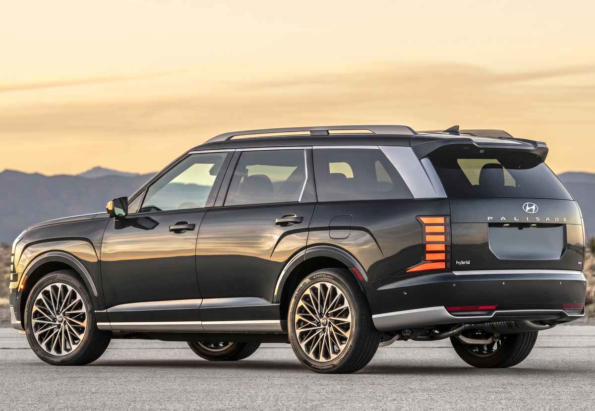 Diseño posterior de la SUV Hyundai Palisade Híbrida en un entorno desértico, resaltando sus barras de techo plateadas y las nuevas luces traseras LED divididas en segmentos.