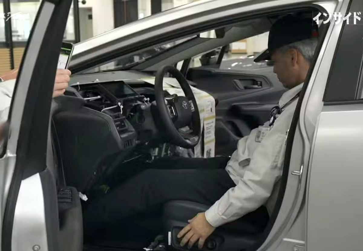 Interior en fase de pruebas del nuevo Toyota Corolla 2027, revelando a un ingeniero al volante con un tablero en desarrollo, volante multifunción y diversos componentes de cableado expuestos.