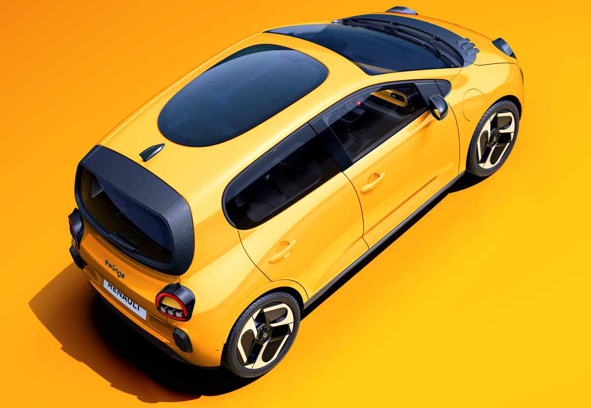 Plano superior de tres cuartos trasero del Renault Twingo E-Tech amarillo en estudio, mostrando en detalle el nuevo techo panorámico de cristal oscuro denominado Twingobay y su portón trasero negro.