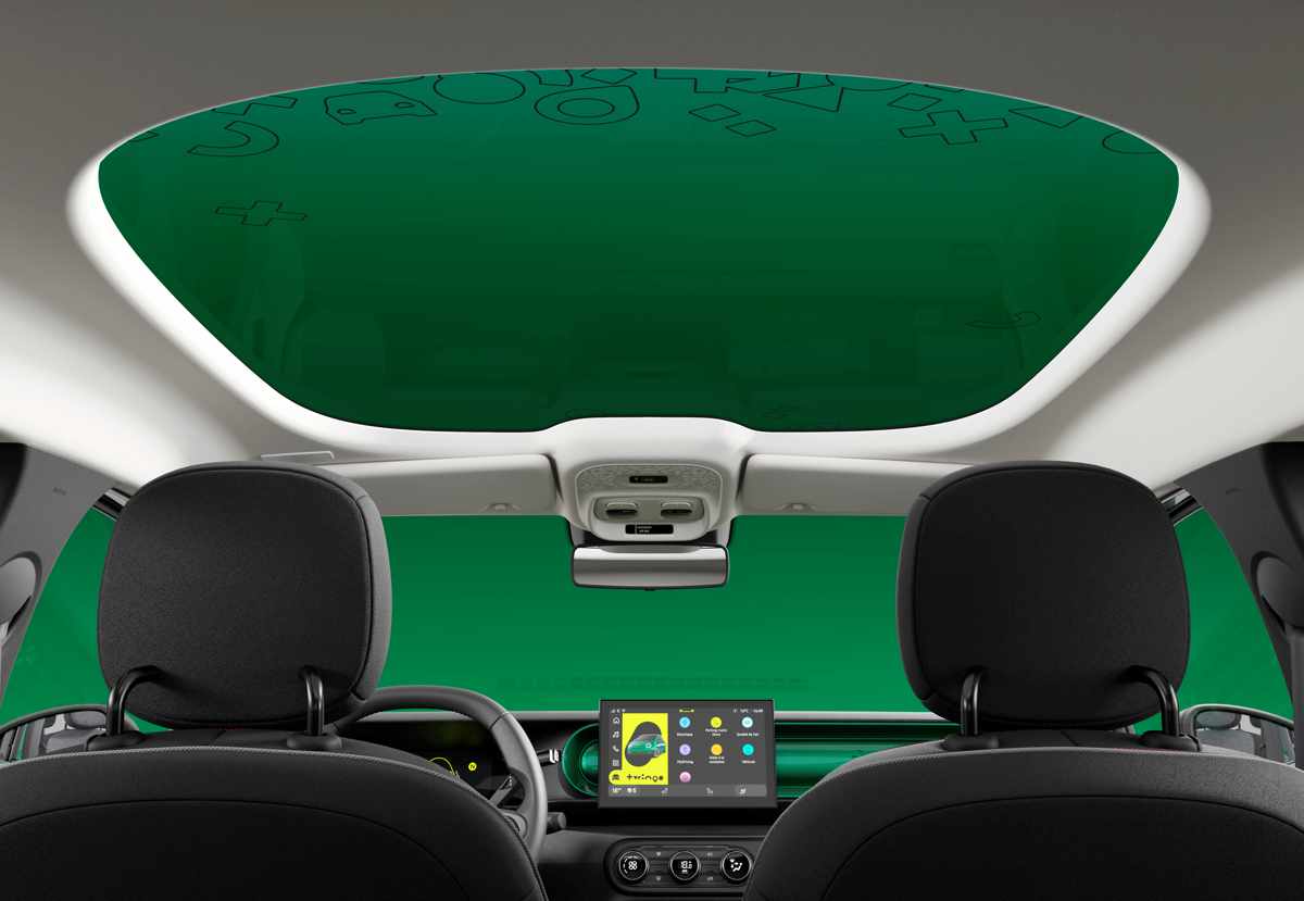 Vista interior de la cabina del Renault Twingo E-Tech, resaltando la gran entrada de luz a través del techo de cristal fijo Twingobay sobre los asientos delanteros y traseros.
